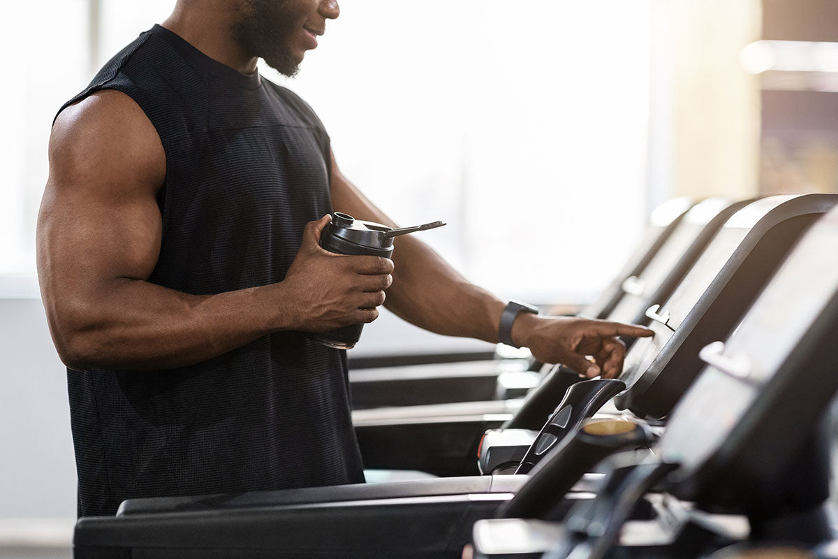At the gym getting ready to use the treadmill