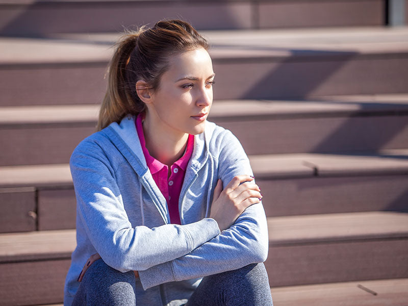 Female athlete thinking