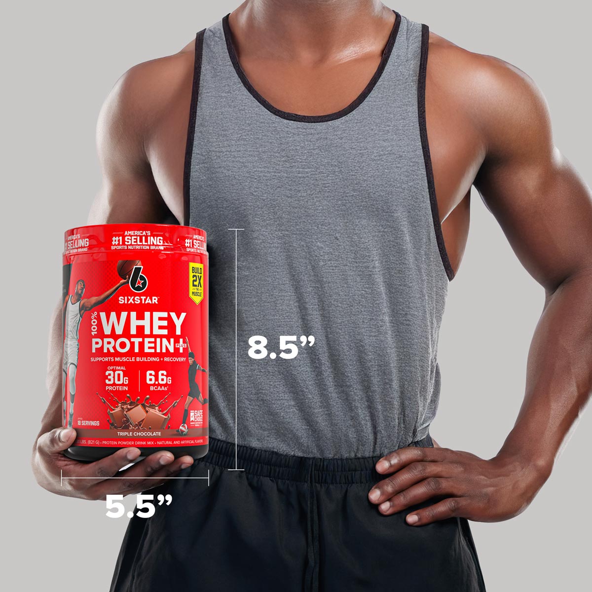 Athlete holding a SIXSTAR 100% Whey Protein Plus Triple Chocolate tub with labeled product dimensions of 8.5 inches tall and 5.5 inches wide for size reference.